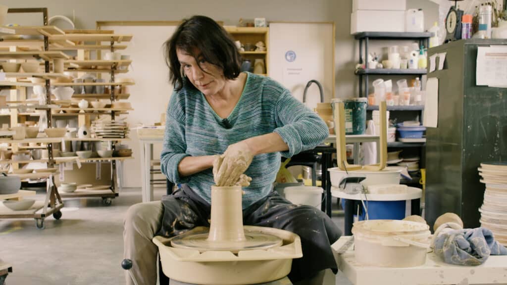 Cursist docente Françoise Busin in haar atelier tijdens de het draaien van een hoge pot