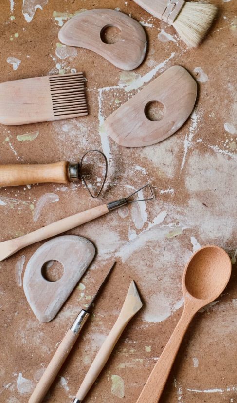 Working tools in a pottery workshop on a wooden board